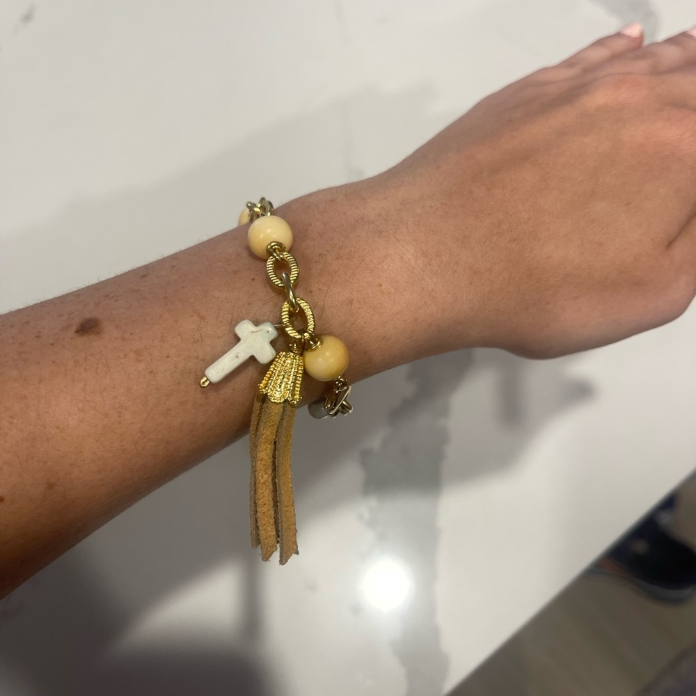Beaded cross bracelet with gold accents